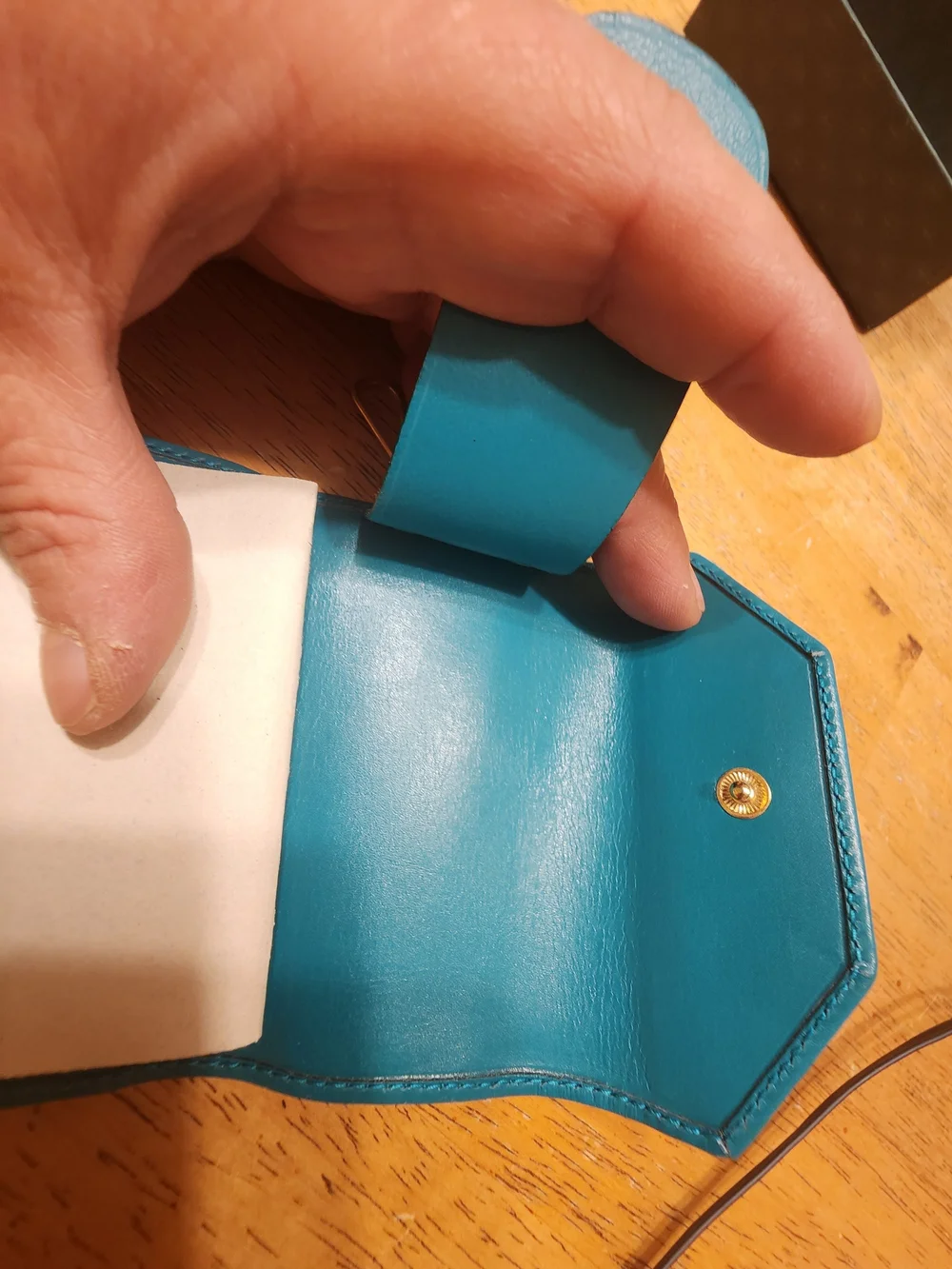 vintage Gucci teal leather key case featuring a distinctive cabochon stone